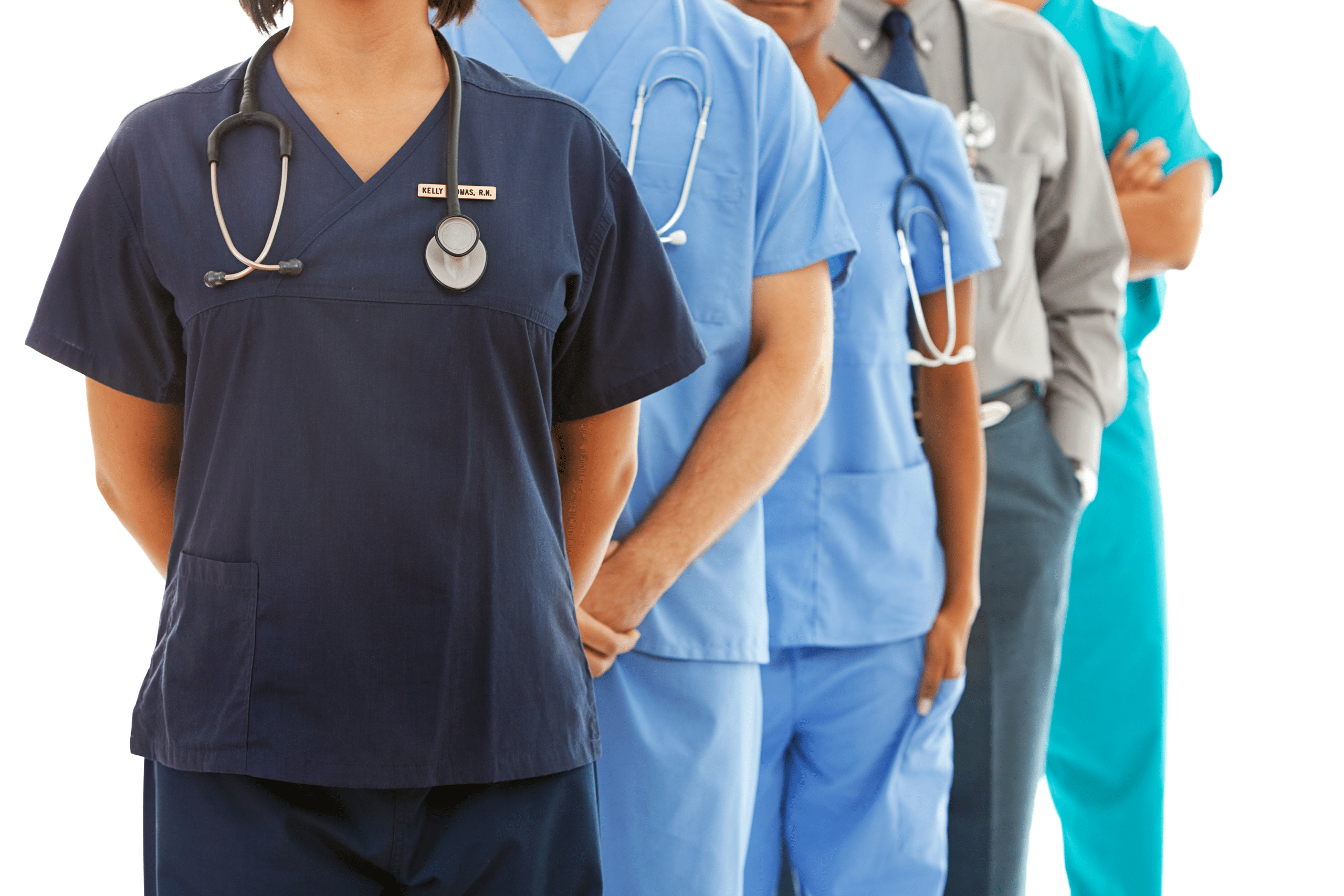 Healthcare professionals in scrubs stand in a line, showcasing a variety of roles and expertise. Relevant for medical staffing discussions.