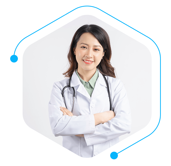 Confident healthcare professional in a white lab coat, smiling with arms crossed, and a stethoscope around her neck, symbolizing medical expertise.