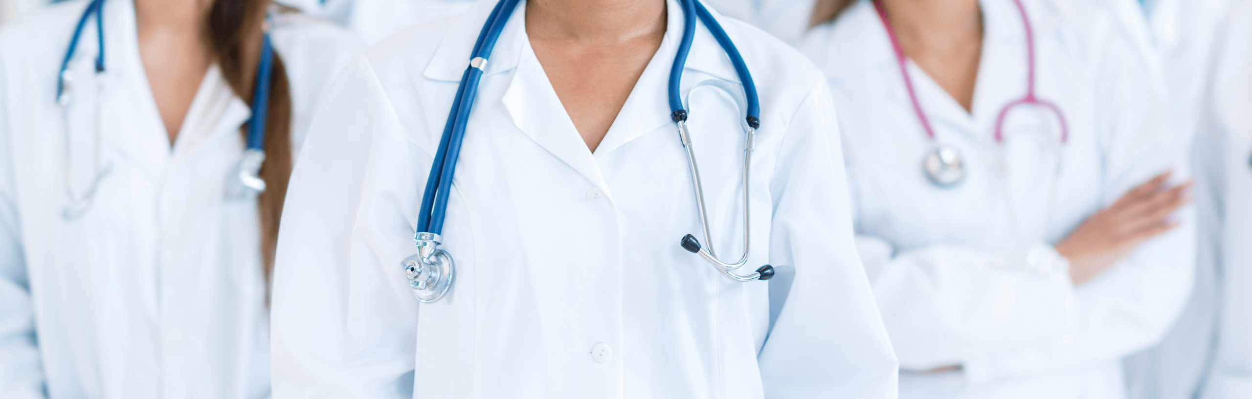 Medical team in white lab coats, prominently displaying stethoscopes, showcasing collaboration and professionalism in a healthcare setting.